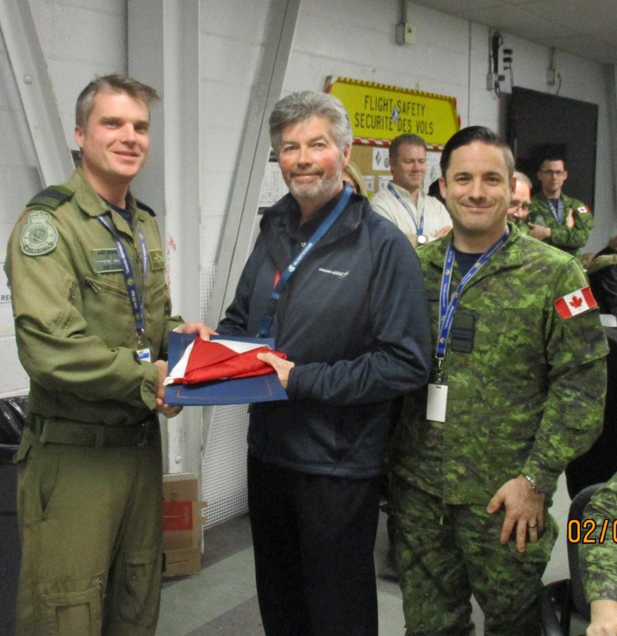 Ed receiving an accommodation from the commanding officer of 436 Squadron on behalf of the CFO for support to Op Presence.